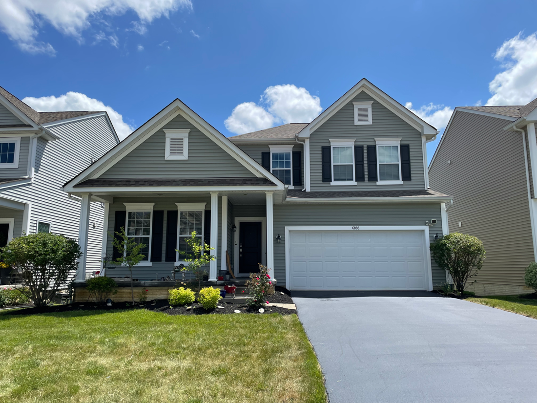 House with algae streaks on siding before Pinnacle Wash treatment in Reynoldsburg